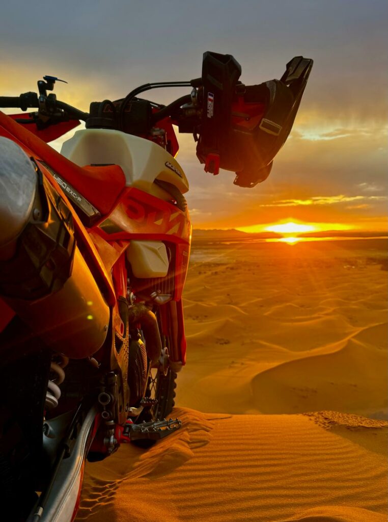 Stage moto tout-terrain Maroc au coucher de soleil sur piste désertique